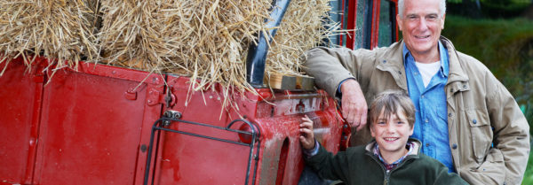 farmer with grandson next to truck