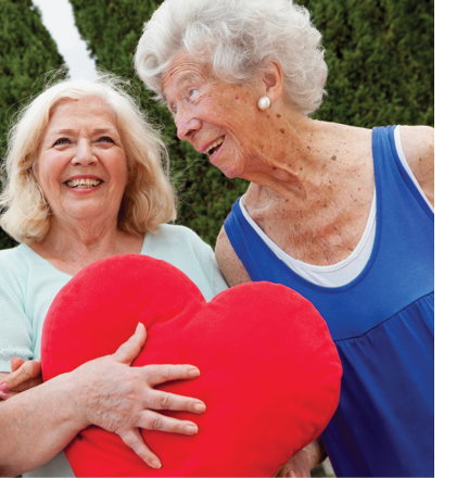 senior ladies holding heart shaped pillow