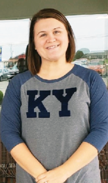 employee of the month LeAnne Huber standing for photo wearing grey and blue baseball tee with the letters KY on the front