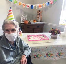 Springfield Nursing and Rehab Resident Peggy P. sitting at a table with her birthday cake