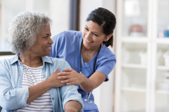 female nurse helping a senior woman