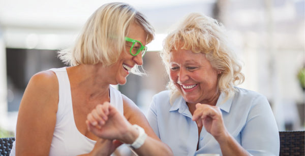 two senior women laughing together