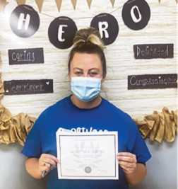 Springfield Nursing and Rehab employee of the month Whitney standing with her certificate