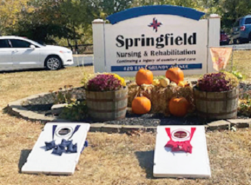 Large orange pumpkins displayed in front of Springfield Nursing and Rehab sign