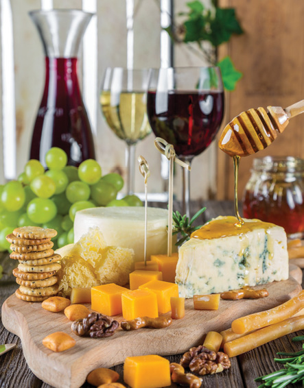 image of glasses of wine and cheese board for national wine and cheese day